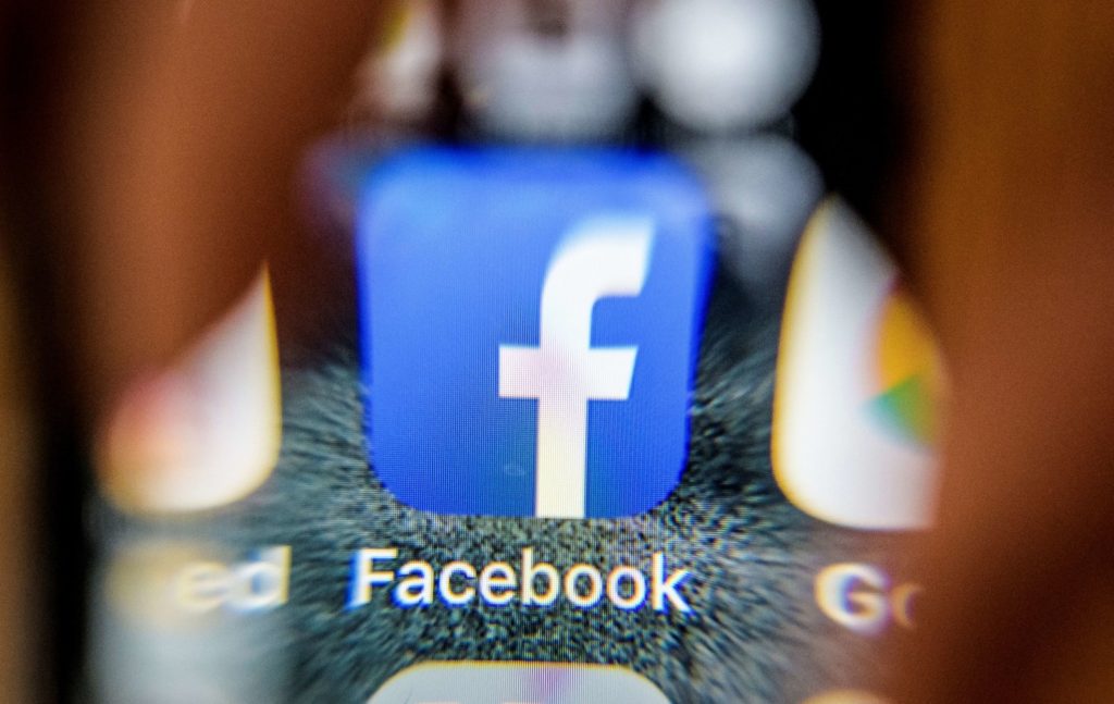 An illustration picture taken through a magnifying glass on March 28, 2018 in Moscow shows the icon for the social networking app Facebook on a smart phone screen. Facebook said on March 28, 2018 it would overhaul its privacy settings tools to put users "more in control" of their information on the social media website. The updates include improving ease of access to Facebook's user settings, a privacy shortcuts menu and tools to search for, download and delete personal data stored by Facebook. / AFP PHOTO / Mladen ANTONOV (Photo credit should read MLADEN ANTONOV/AFP/Getty Images)